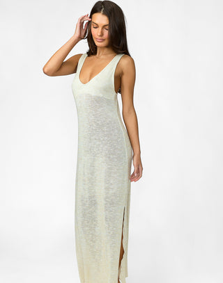 Woman wearing a long, light-colored dress against a white background