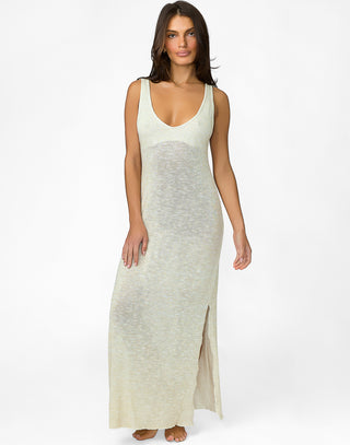 Woman wearing a long, light-colored dress on a white background