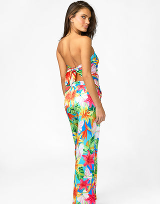 Woman wearing a colorful floral jumpsuit on a white background