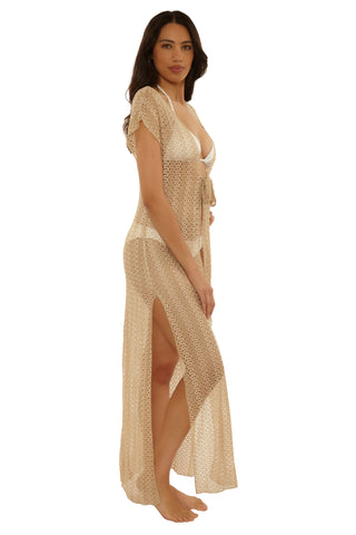 Woman wearing a beige mesh cover-up dress on a white background