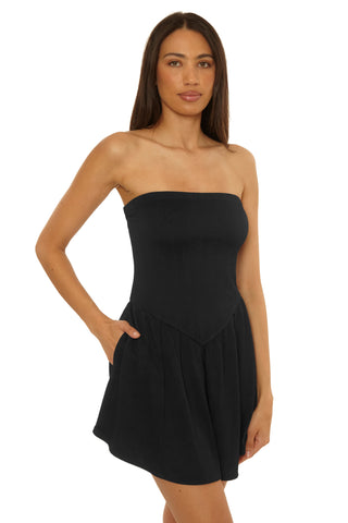 Woman wearing a black strapless dress on a white background