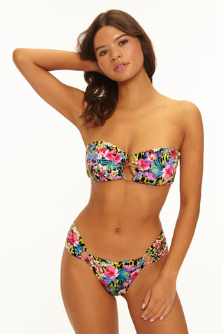 Woman wearing a colorful floral bikini on a white background