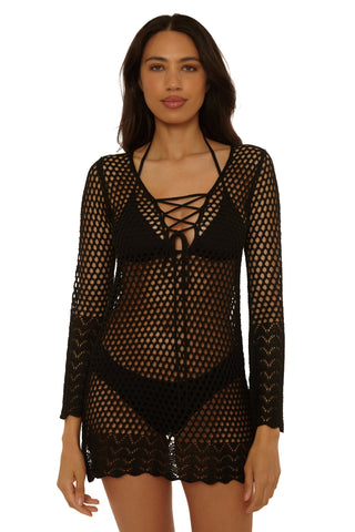 Woman wearing a black fishnet outfit on a white background