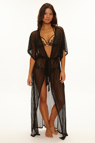 Woman wearing a black lace lingerie set on a white background